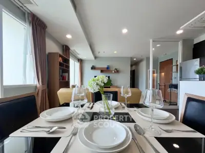 Modern dining area with elegant table setting in a stylish open-plan living room.