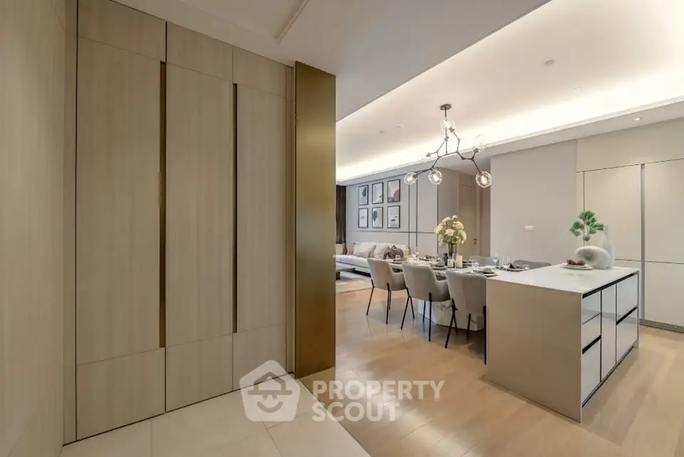 Modern open-plan living and dining area with elegant lighting and sleek design.