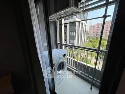 Compact balcony with washing machine and city view in modern apartment