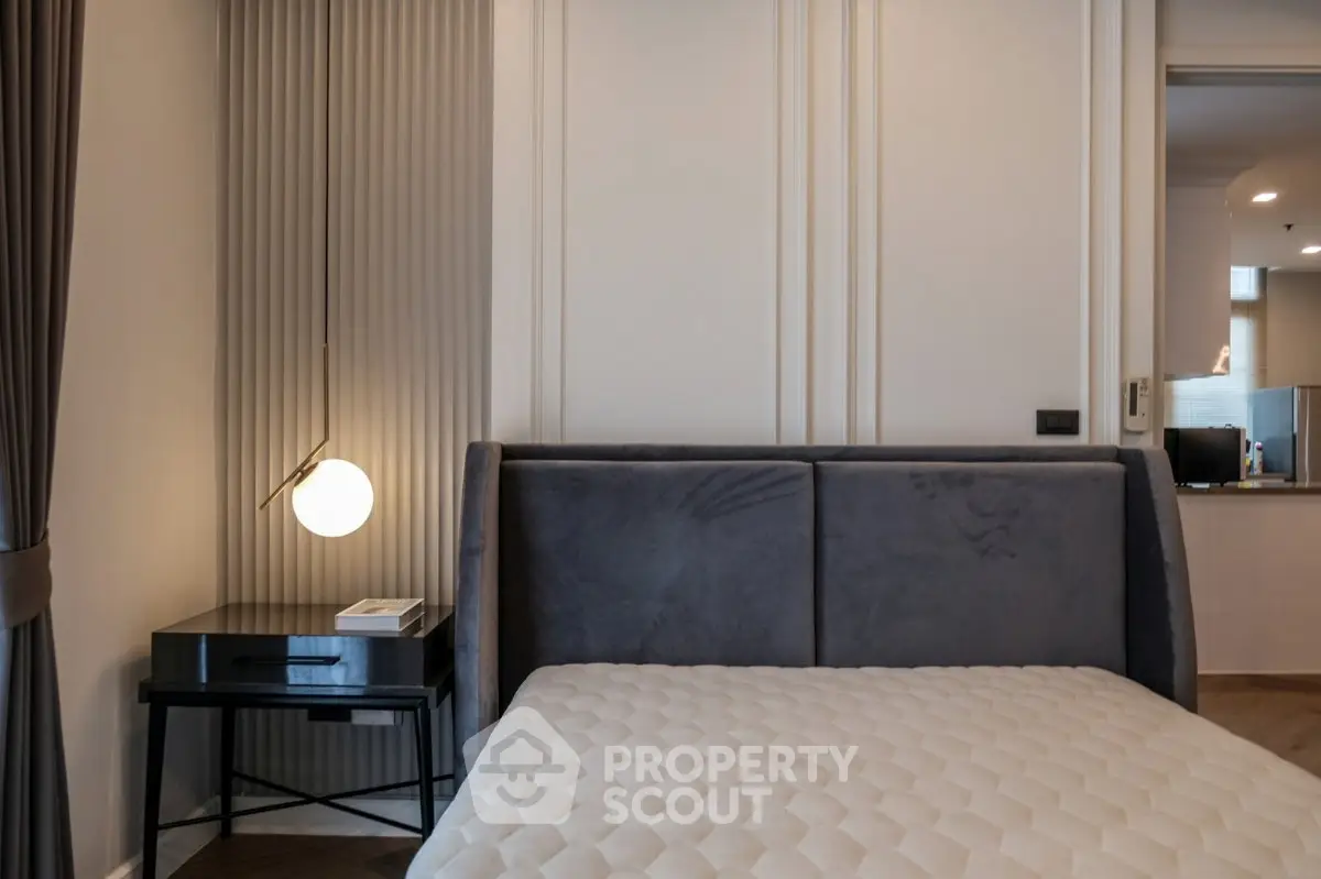 Modern bedroom with stylish decor and cozy lighting in a contemporary apartment.