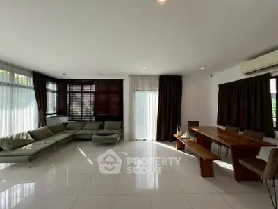 Spacious living room with modern furniture and large windows for natural light.