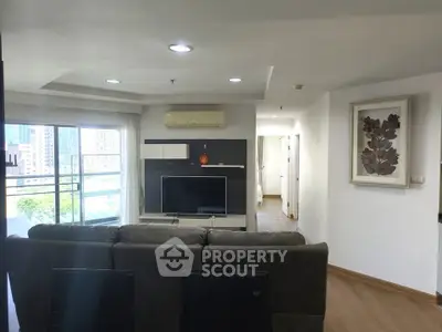 Spacious modern living room with large windows and city view, featuring stylish decor and comfortable seating.