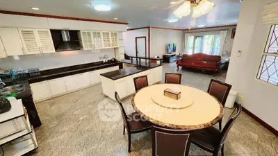 Spacious open-layout kitchen and dining area with elegant furnishings