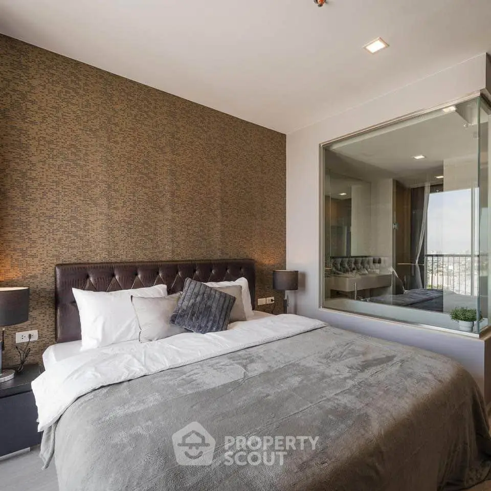 Luxurious bedroom with elegant decor and large window offering stunning views.