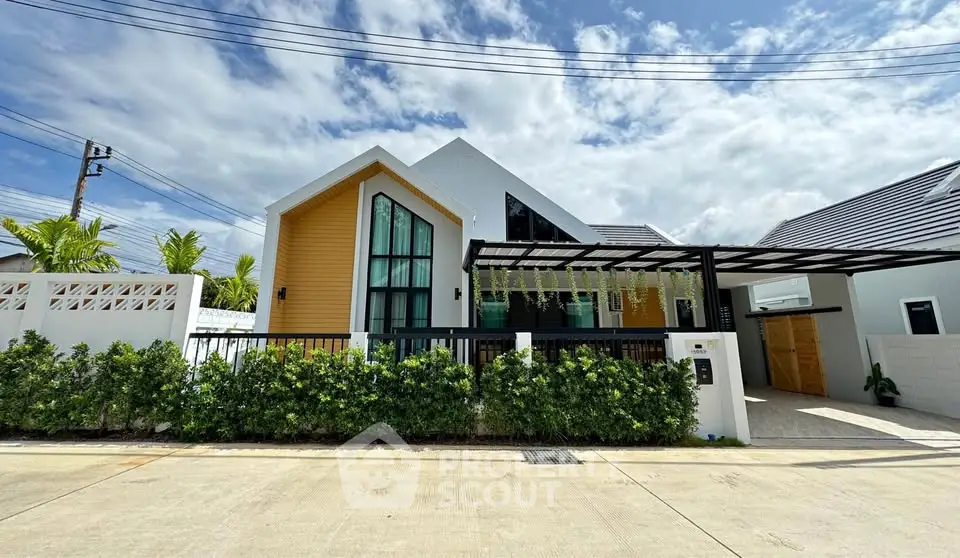 Modern single-story house with unique architecture and lush greenery in a serene neighborhood.