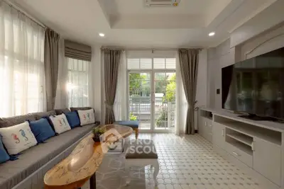 Spacious living room with modern decor and large windows for natural light.