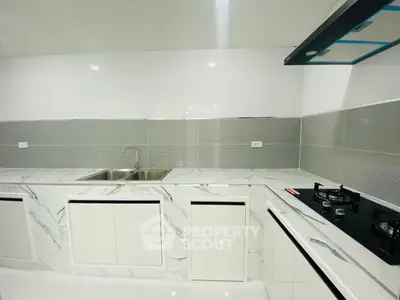 Modern kitchen with sleek marble countertops and gas stove