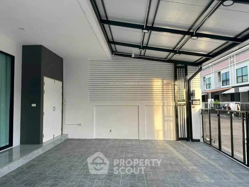 Modern covered parking area with sleek design and tiled flooring