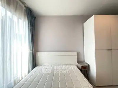 Modern minimalist bedroom with large window and white furniture