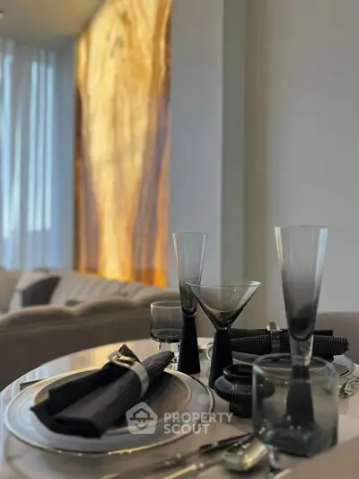 Elegant dining setup with modern glassware and soft lighting in a stylish living space.