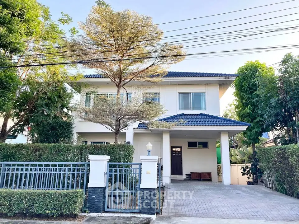 Charming two-story house with modern design and spacious driveway in a serene neighborhood.