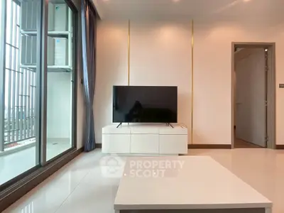Modern living room with sleek TV setup and balcony view