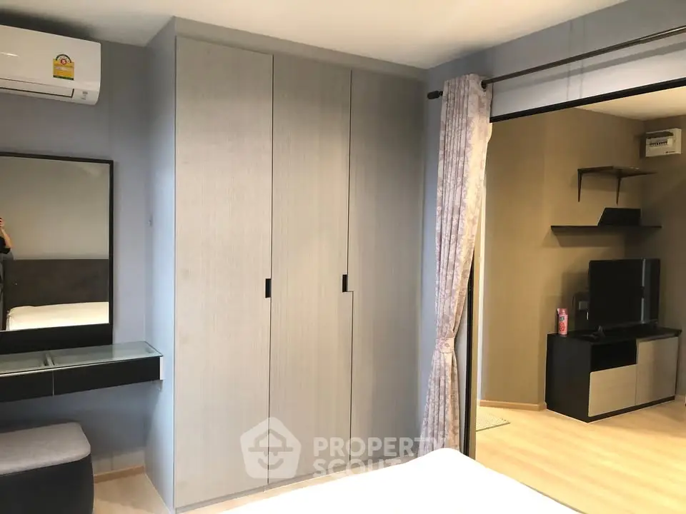 Modern bedroom with sleek wardrobe and air conditioning in stylish apartment