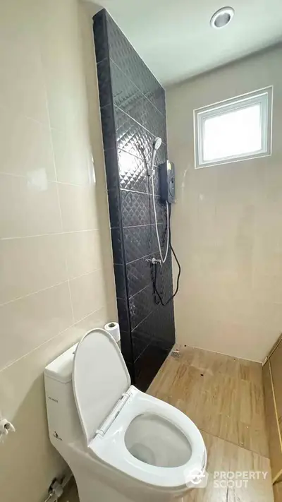 Modern bathroom with sleek shower and natural light window