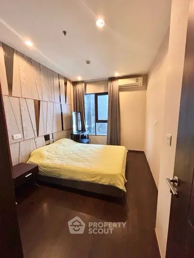 Modern bedroom with stylish wood paneling and cozy lighting