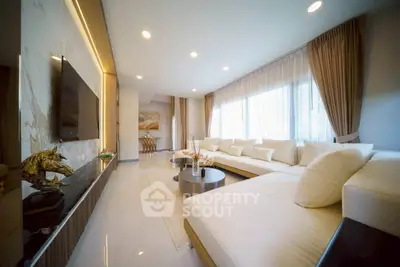 Luxurious modern living room with elegant decor and spacious seating area, perfect for relaxation and entertainment.