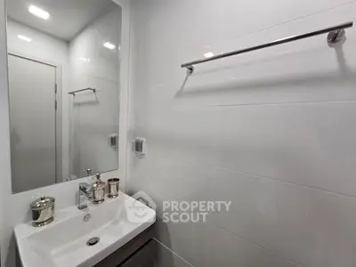 Modern bathroom with sleek white tiles and stylish fixtures