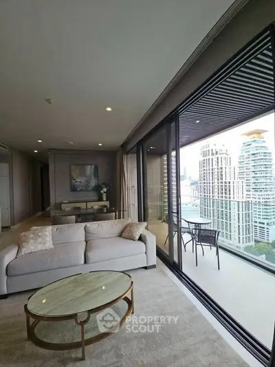 Luxurious living room with stunning city view and spacious balcony in modern apartment.