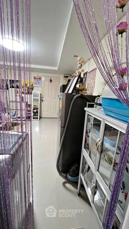 Cozy interior with modern decor and stylish shelving in a compact living space.