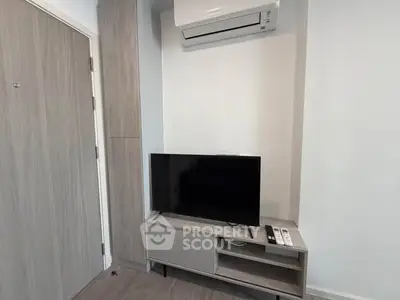 Modern living room with air conditioner and TV setup