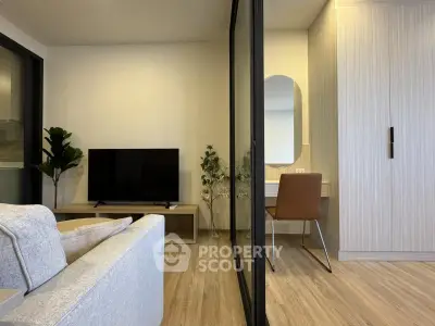 Modern living room with TV, sofa, and stylish decor in a cozy apartment.