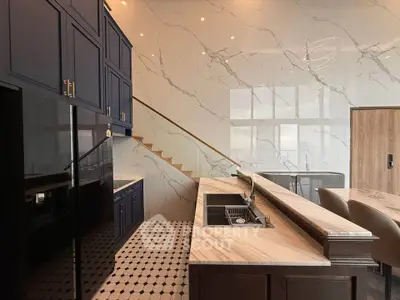 Luxurious modern kitchen with marble countertops and elegant cabinetry