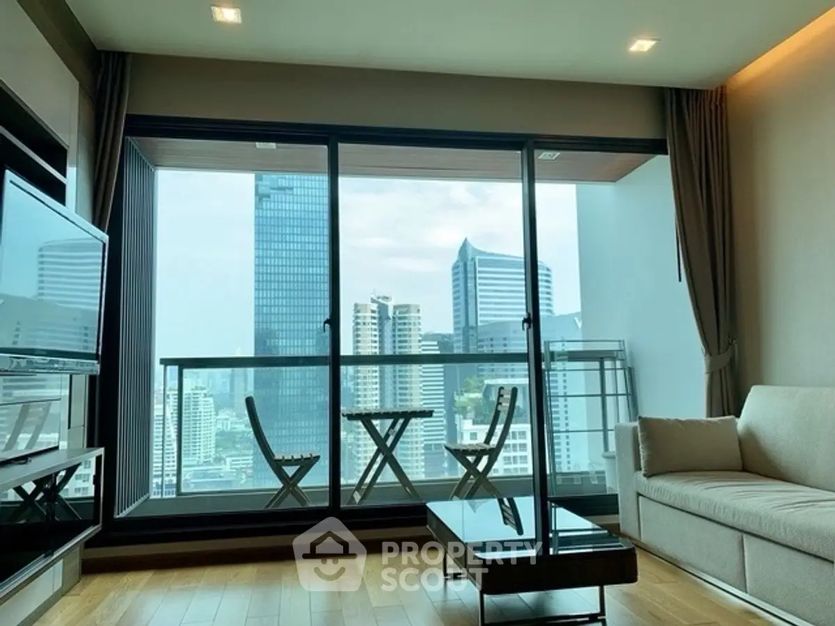 Modern living room with city view and balcony in high-rise apartment.