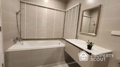 Modern bathroom with bathtub and sleek vanity unit