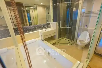Luxurious bathroom with jacuzzi tub and glass shower enclosure