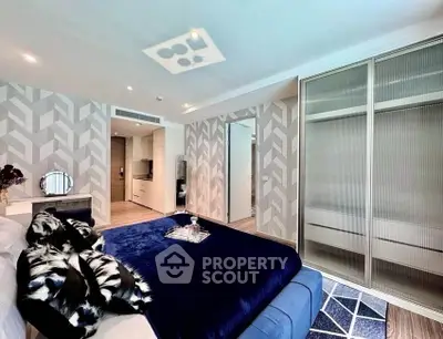 Luxurious bedroom with modern decor and spacious closet in upscale apartment.