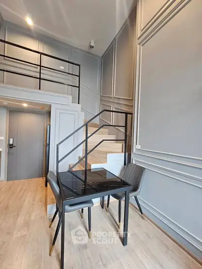 Modern duplex apartment with stylish staircase and elegant dining area