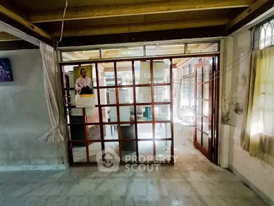 Spacious interior with glass doors and tiled flooring, ideal for natural light and open living.