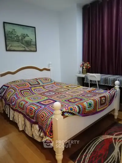 Cozy bedroom with colorful crochet bedspread and elegant decor