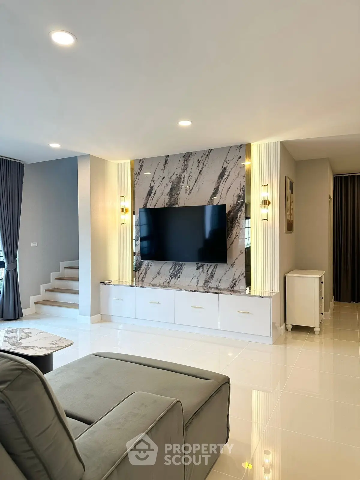 Modern living room with marble accent wall and sleek TV setup