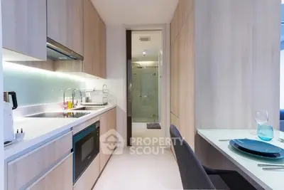 Modern kitchen with sleek cabinetry and integrated appliances in a stylish apartment.
