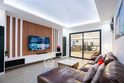 Luxurious modern living room with sleek design and large TV, perfect for entertainment.