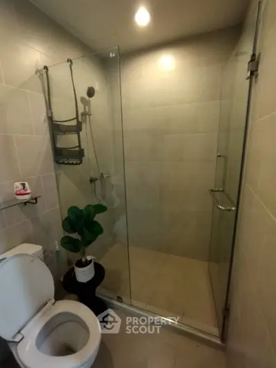 Modern bathroom with glass shower enclosure and sleek tile design