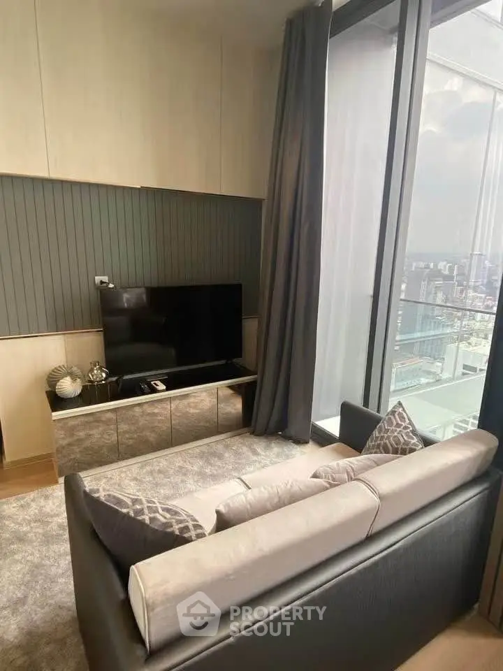 Modern living room with sleek furniture and city view from large windows