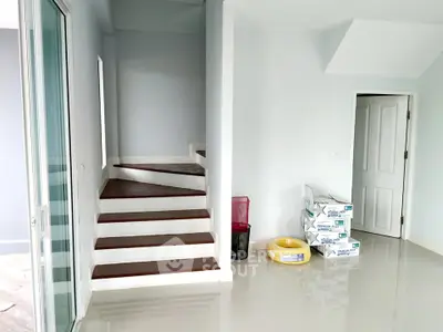 Modern interior with staircase and sleek flooring in a bright, open space