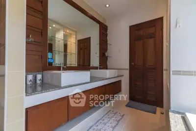 Luxurious bathroom with dual sinks and elegant wooden cabinetry