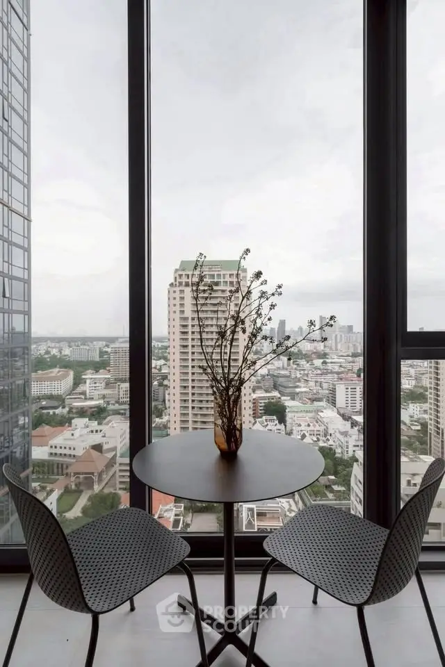 Stunning city view from modern high-rise apartment with floor-to-ceiling windows and elegant decor.