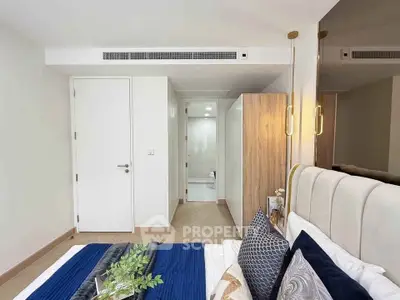 Modern bedroom with stylish decor and ensuite bathroom in a contemporary apartment.