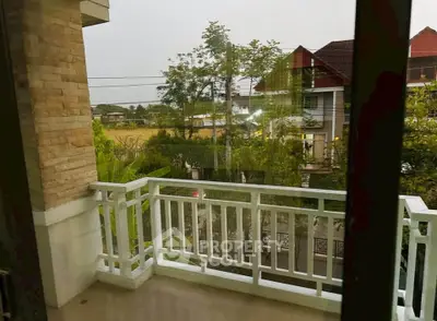 Charming balcony view overlooking lush greenery and modern neighborhood, perfect for relaxation and enjoying nature.