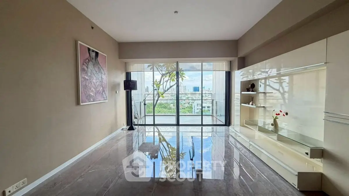 Spacious living room with large windows offering stunning city views and elegant decor.