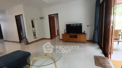 Spacious living room with modern furniture and large windows for natural light.