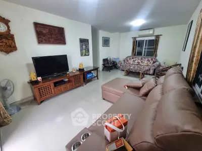 Spacious living room with modern furniture and entertainment center