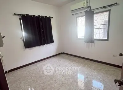 Spacious unfurnished room with tiled flooring and air conditioning, perfect for customization.