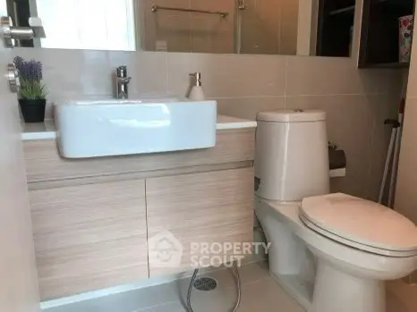 Modern bathroom with sleek fixtures and stylish vanity in a contemporary home.