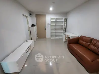 Modern living room with sleek furniture and ample storage space