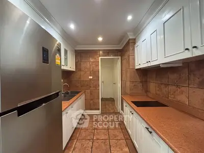 Spacious kitchen with modern appliances and ample storage in a stylish home.
